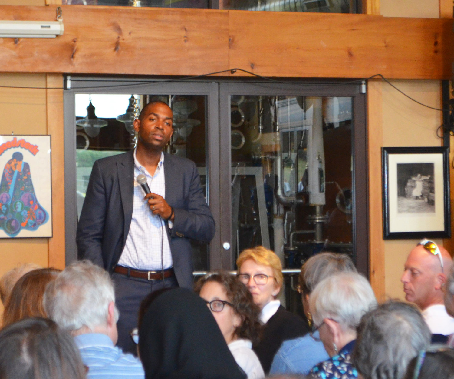 Congressman Antonio Delgado listens to a question from the audience at a town hall meeting a Catskill Distillery on July 31.