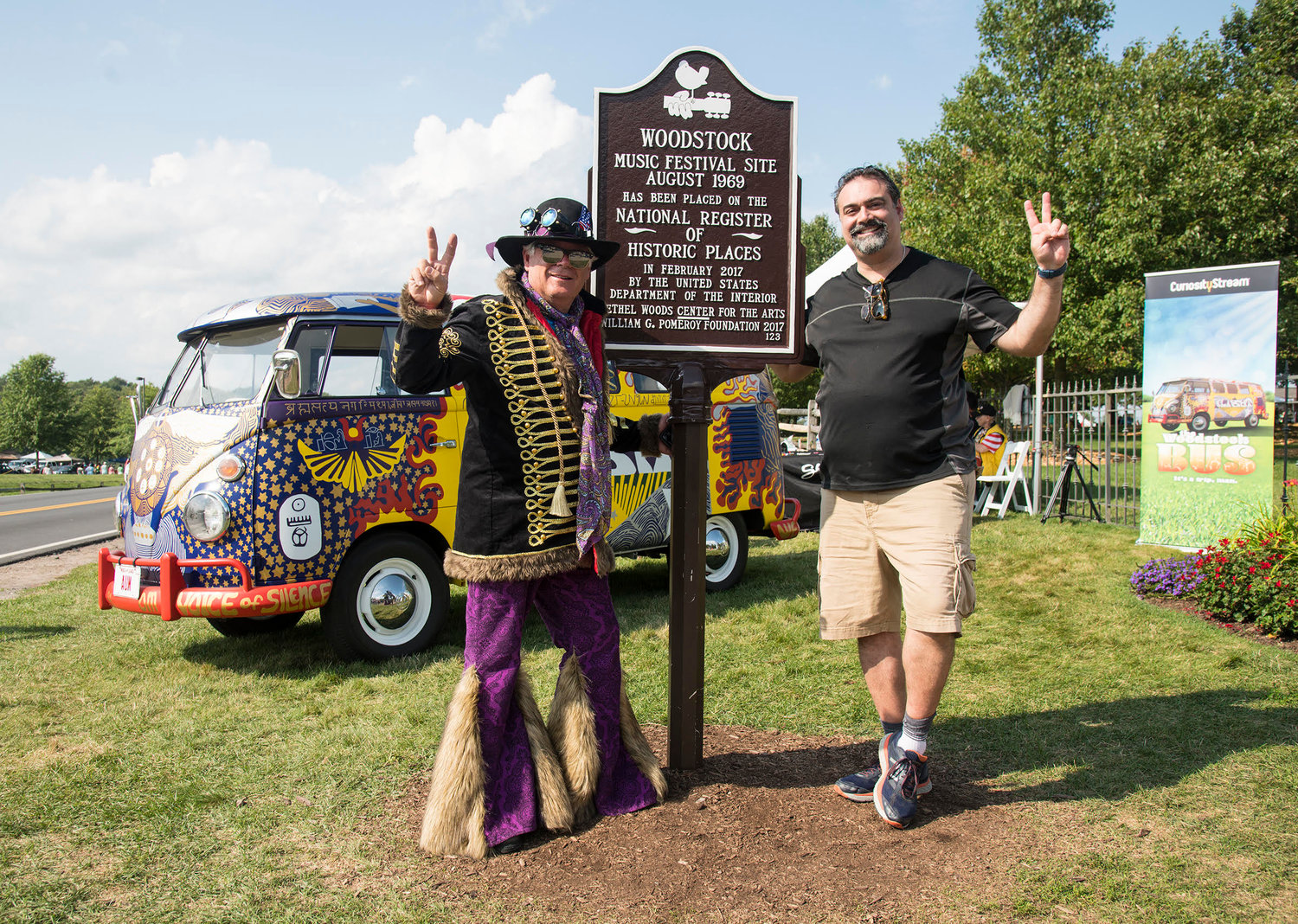 The historical marker right outside of the entrance to the Bethel Woods Concert site and Museum was a busy place for people to meet, greet, and be photographed. Pictured are two concert goers unknown to one another who decided to pose together.