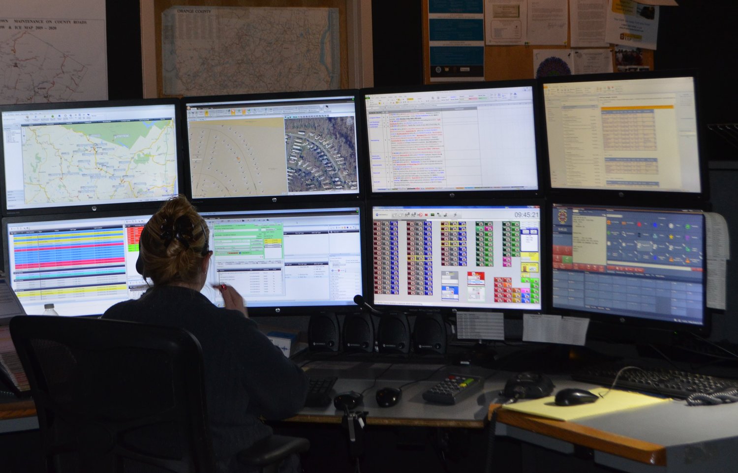 A dispatcher is surrounded by screens and information at the Sullivan County 911 Center.