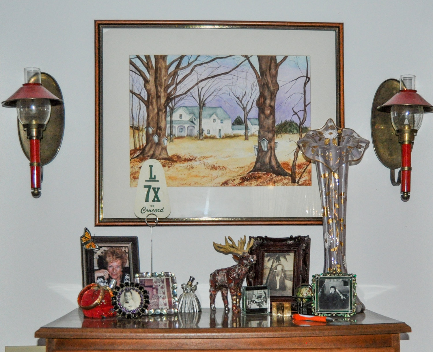 The watercolor painting above the highboy in my bedroom was painted by my incredibly talented mother who's pictured here in the lower left, just opposite of her father who is sporting a grass skirt (another story) in an antique frame opposite mom. Hurricane lamps, a sequined moose and a Venetian glass vase from the 1930s complete the desired effect. Funky. Eclectic. Chic. IMHO.
