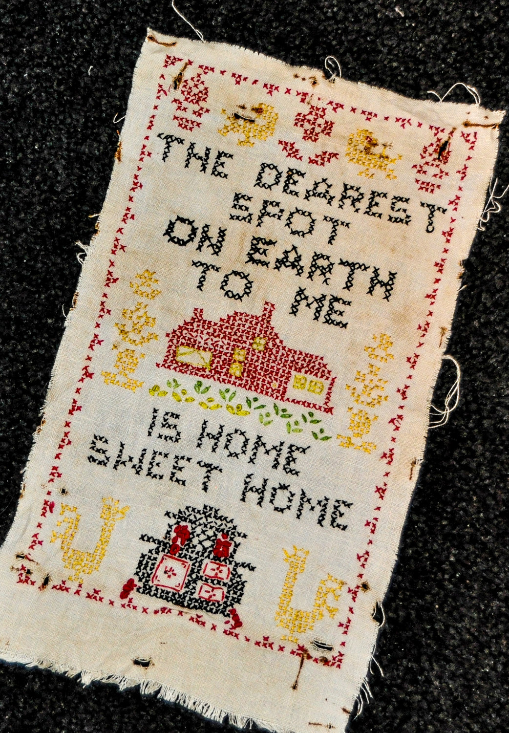 This sampler I picked up years ago in an antique store really says it all. Like many items scattered throughout my house, it's a little bit tattered but tells a story. Somebody's grandmother stitched it, I'm sure, but she doesn't actually live here, regardless of what visitors have asked in the past.
