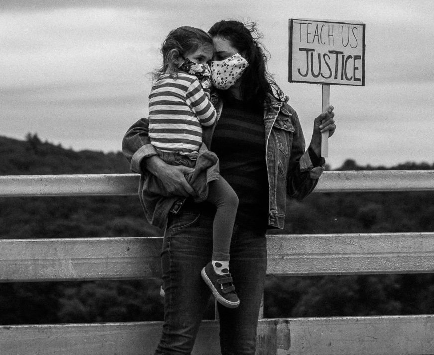 A protestor holds her daughter on the Narrowsburg Bridge.