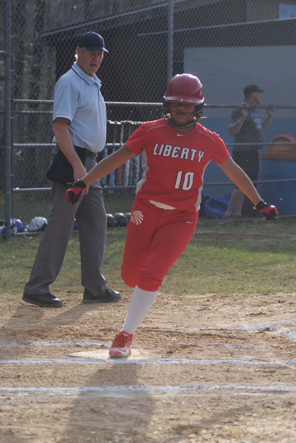 Safe passage. Liberty’s Anna Barragan scores a run in the Lady Indians 16-0 five-inning win over the home team.