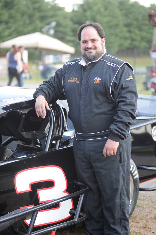 Standing proud. Mike Dutka is pictured with his racecar just before the first races of the new season at Bethel Motor Speedway on June 20.