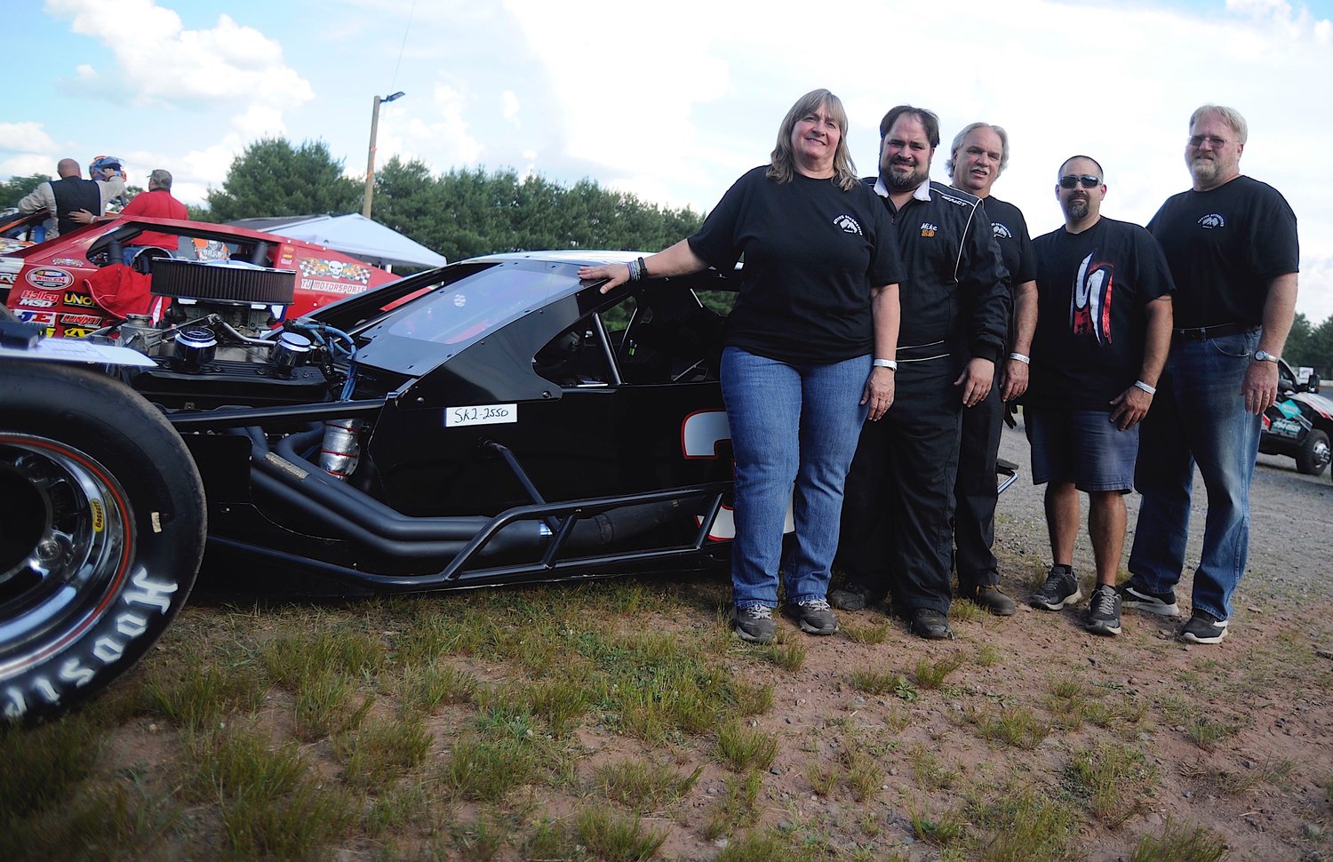 The race team: Mary Dutka, mother, left; Mike Dutka, racecar driver; John Dutka, father and crew chief; John Dutka Jr., brother and pit crew; Ed Darrow, “the tire and gas guy.”