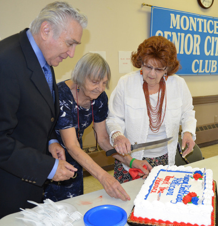 Former Congressman Maurice Hinchey, left, prepares to cut a Medicare birthday cake with the co-chairs of the Sullivan County Senior Legislative Action Committee (SLAC), Priscilla Bassett and Roz Sharoff, at a SLAC meeting in 2009.