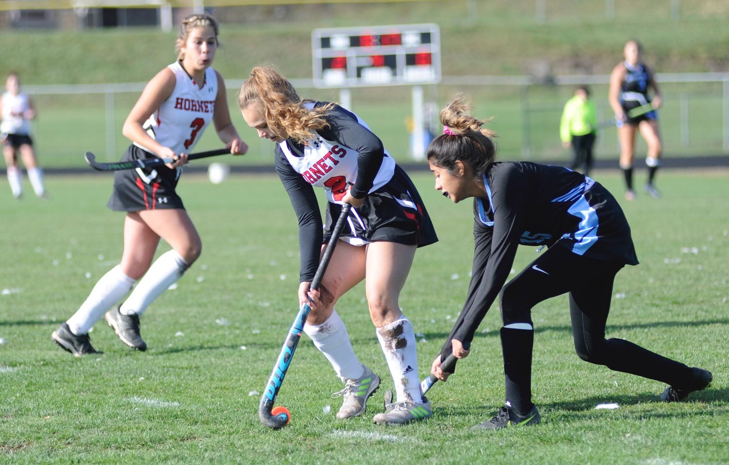 Getting a stick on it. Honesdale’s Jillian Hoey and Wilkes Barre’s Melanie Teletenchi vie for possession, as Hornets' Brynn McGinnis anticipates the handoff.