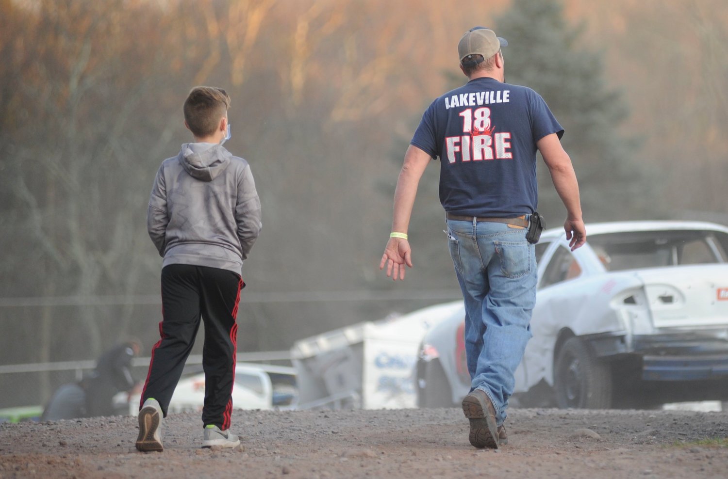 The next generation. A father and son walk the pit area at Bethel Motor Speedway on the last day of the 2020 racing season.