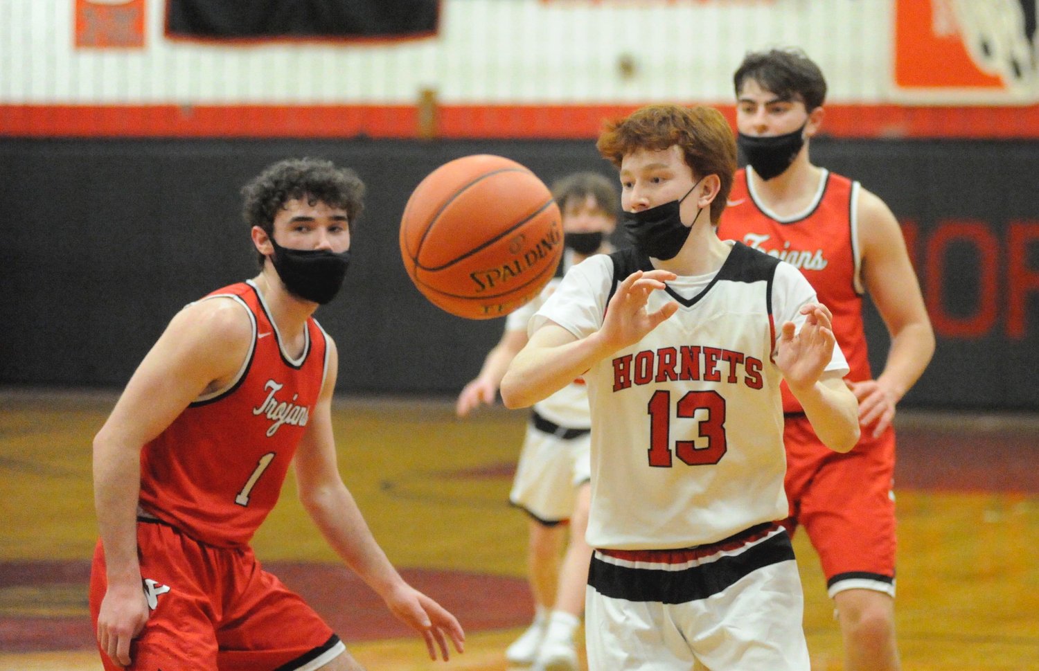 Mid-pass. Honesdale’s Chase Cummings passes to a teammate as Trojans’ Ryan Ruddy defends. Ruddy led all bucketeers with 19 points.
