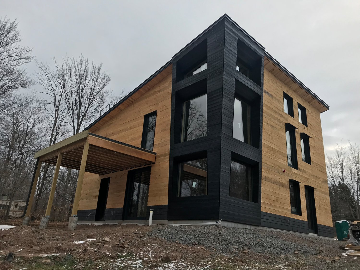 The first house's shell was prefabricated in New Hampshire, shipped to New York, where a crew of four people were able to assemble the building over three days.