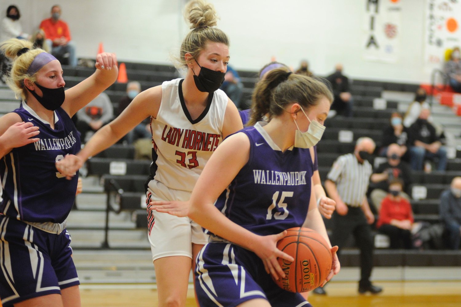 Decision on the boards. Honesdale junior bucketeer Chloe Lyle closes in on Wallenpaupack’s Megan Desmet who posted a game-high 26 points, including going 17/21 at the free-throw line.