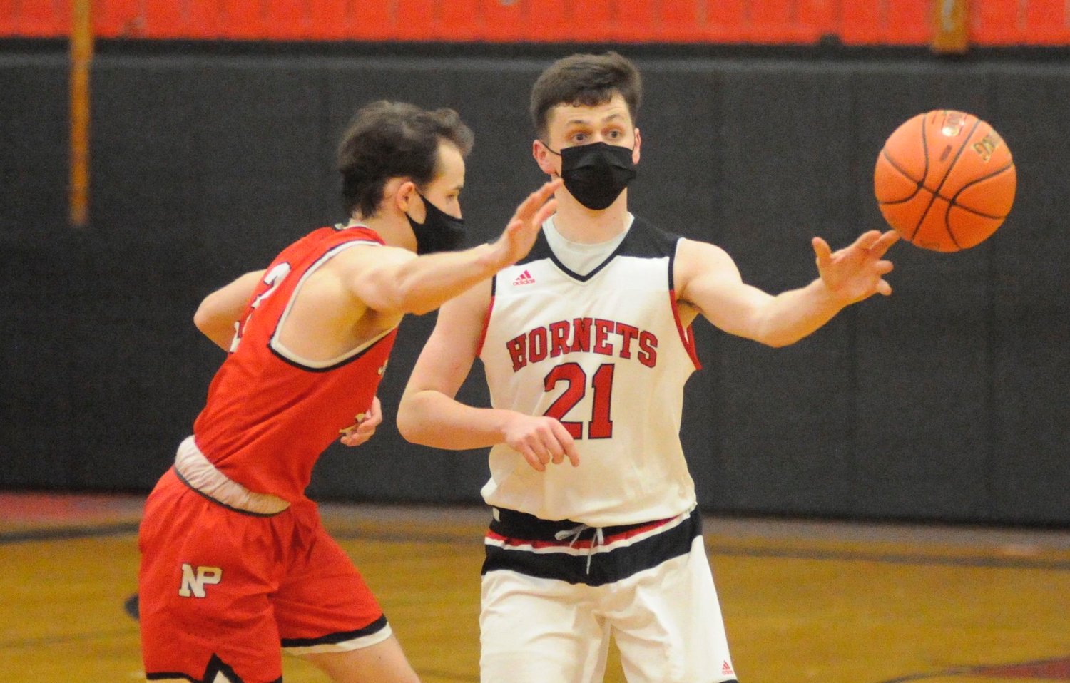Flight of fancy. Honesdale’s Connor Coar passes off to a teammate as North Pocono’s Zack Walsh closes in. Walsh posted 12 points for the Trojans.