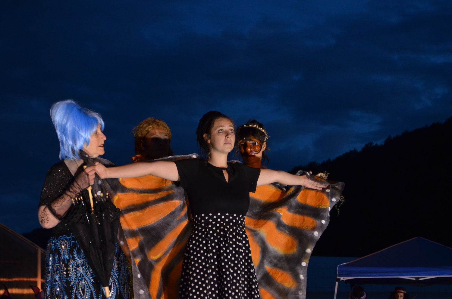 The microcosmic team, represented by Cilly the Microbe (played by Annie Hat, back left), Corn (played by Stefanie Workman) and Fungus (played by Marguerite Boissonnault) supports a Butterfly struggling with the effects of climate change (played by Julia Kehrley).