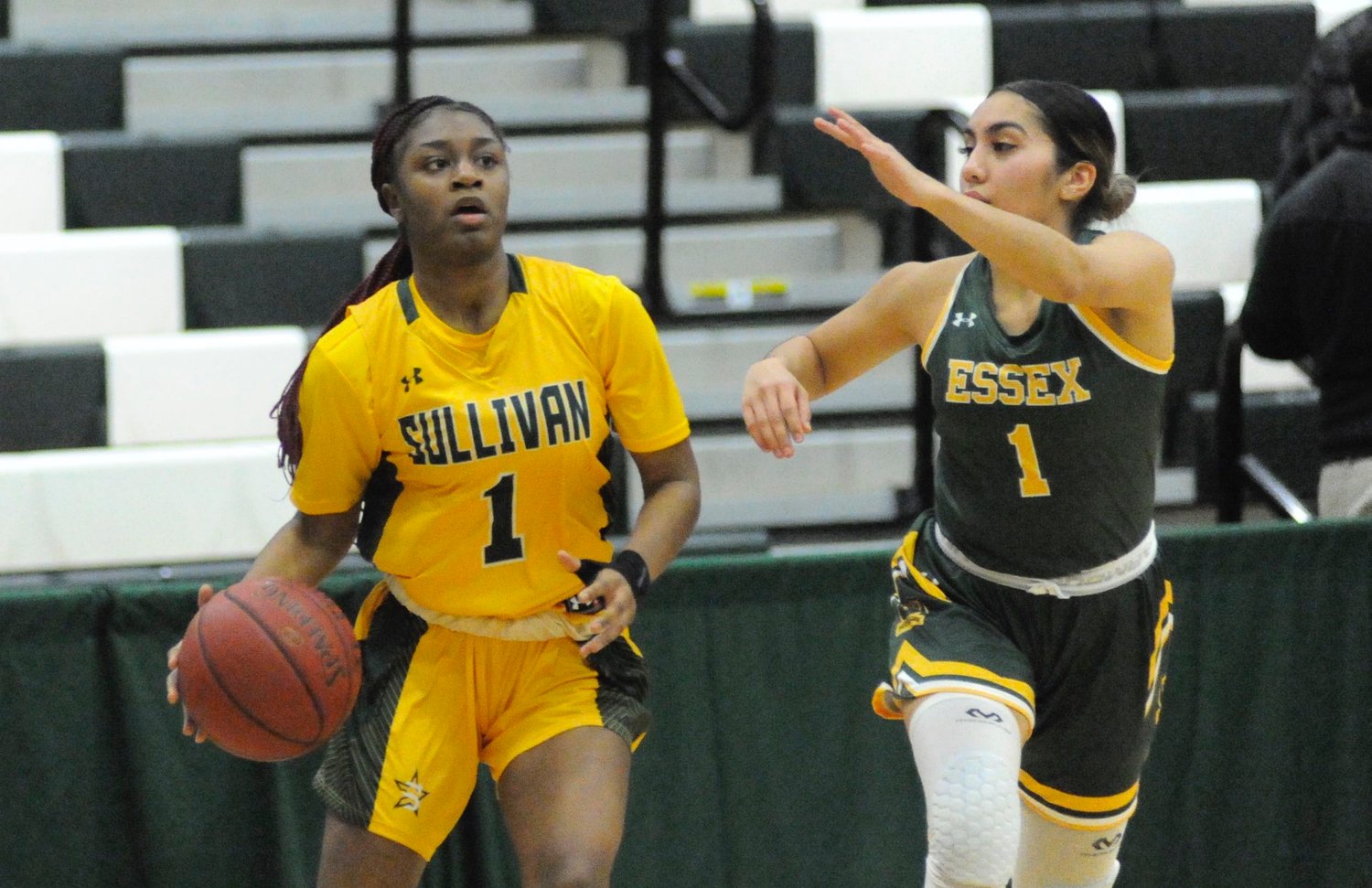 Keyani Sidberry, a sophomore guard for the Lady Generals, aced a three-pointer. A graduate of Park East High School in the Bronx, she is pictured with Ania Martinez of the Lady Wolverines.