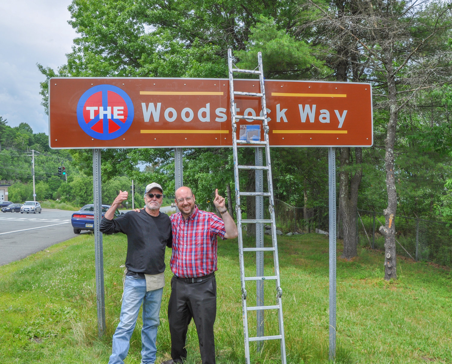 Sullivan County director of communications Dan Hust and artist Paul Kean give the sign enhancement project the thumbs-up.