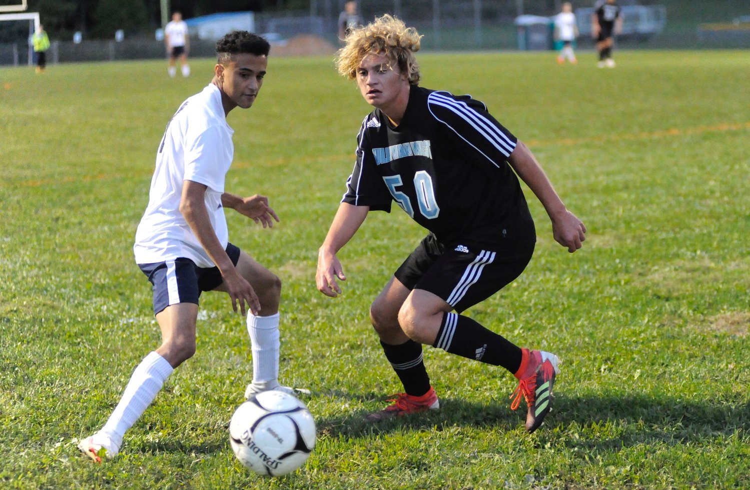 Battle of the booters. Burke’s W. Garcia and Sullivan West’s Charlie Kutschera focus on who’s going to win the ball.