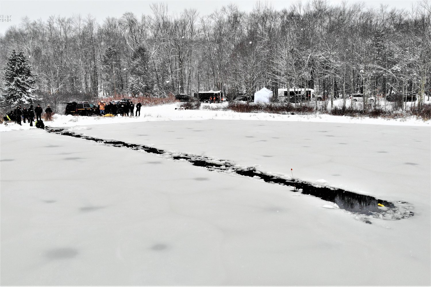 Divers cut a path through the ice to reach the victims.